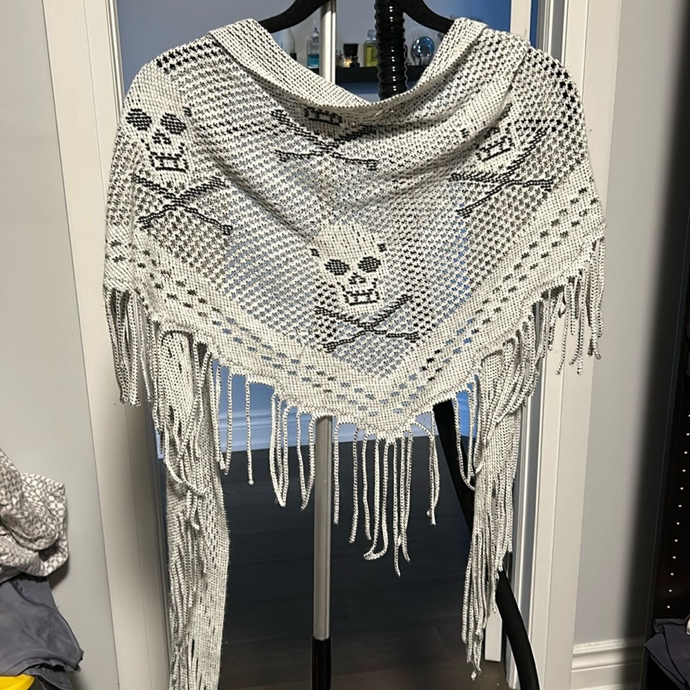 A triangular skull-patterned scarf